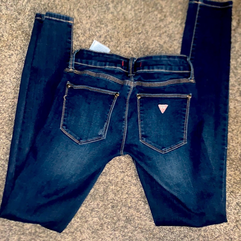 Guess. Dark, distressed, skinny jeans.